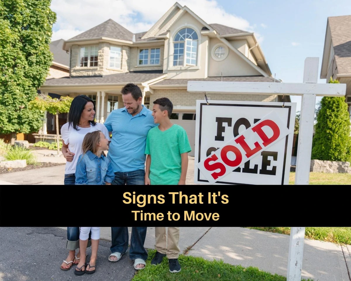 A family in front of a sold home sign